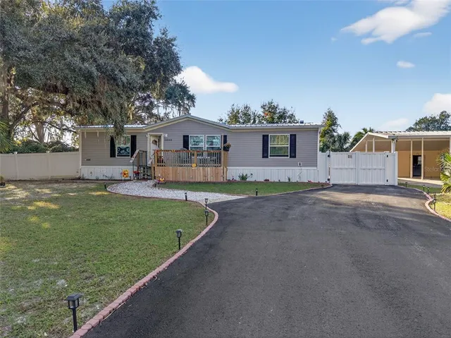 a front view of a house with a garden and yard
