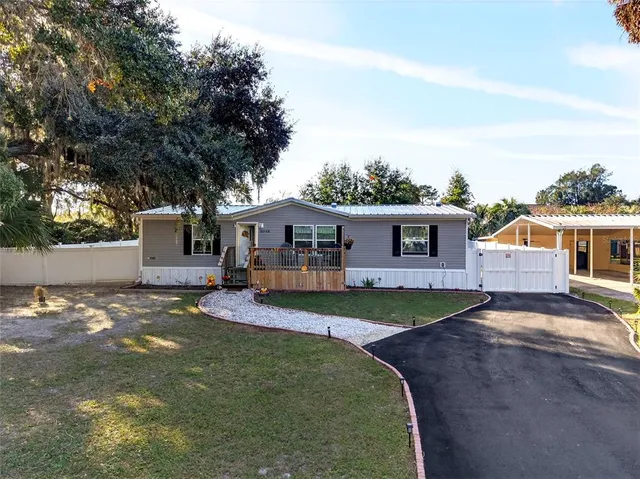 a view of a house with pool and a yard