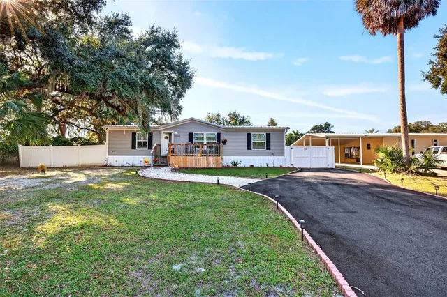 a front view of a house with swimming pool having outdoor seating