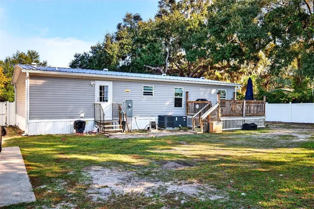 a kitchen with a stove a sink dishwasher and a refrigerator with wooden floor