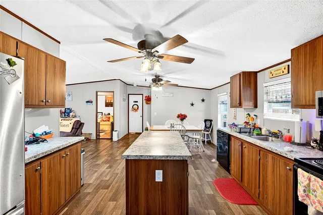 a living room with furniture a flat screen tv and a large window