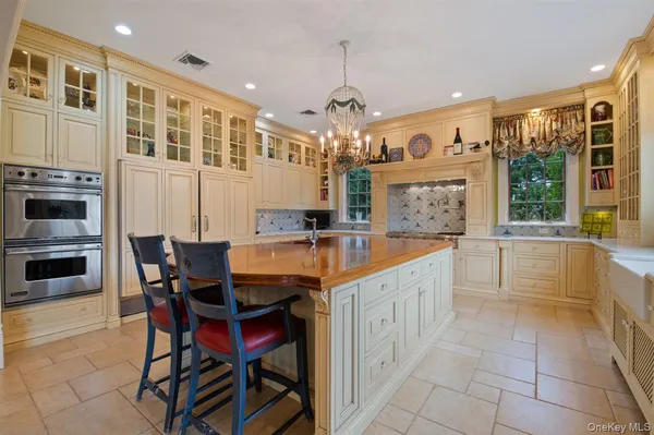 a large kitchen with granite countertop a sink and a refrigerator