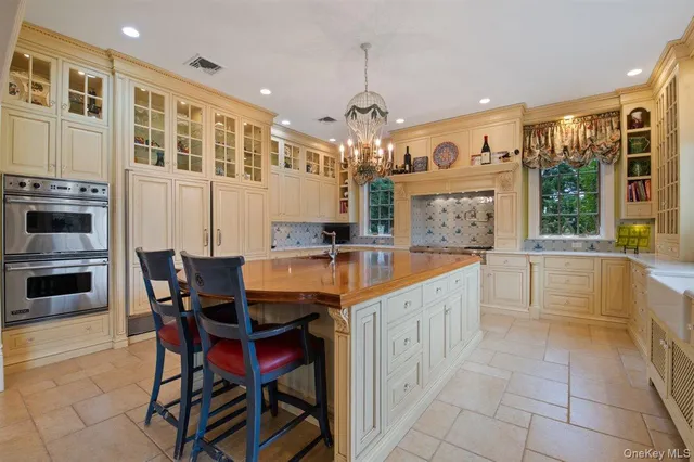 a large kitchen with granite countertop a sink and a refrigerator