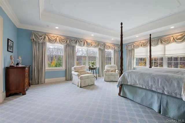 a spacious bedroom with a bed and a large window