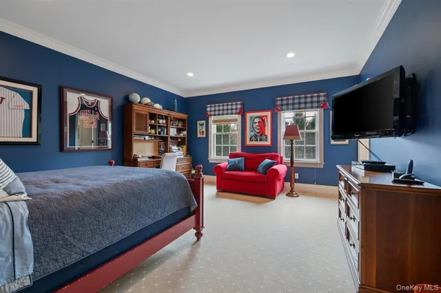 a bedroom with a bed furniture and a flat screen tv