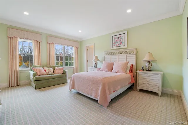 a spacious bedroom with a bed and a couch