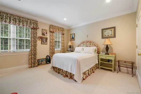 a spacious bedroom with a bed and a large window