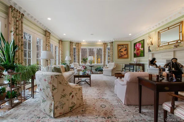 a living room with fireplace furniture and a potted plant