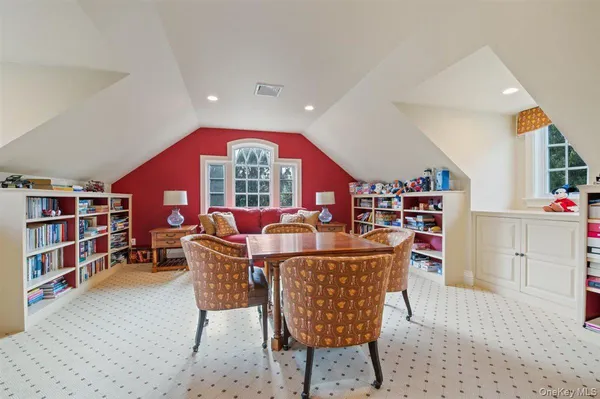 a dining room with furniture and a book shelf