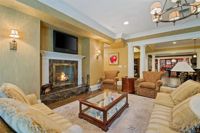 a living room with furniture a flat screen tv and a fireplace