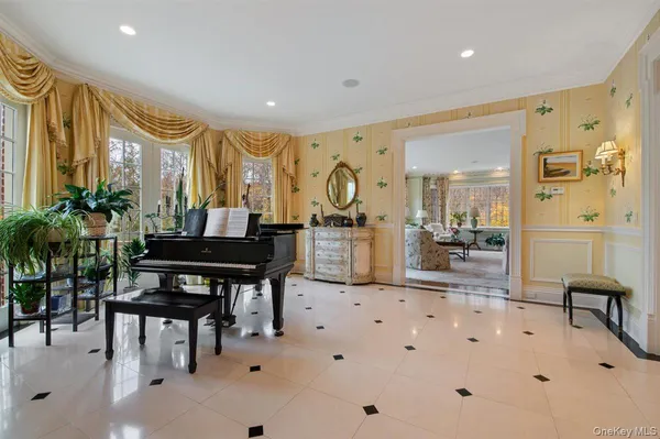 a very nice looking room with a large window and furniture