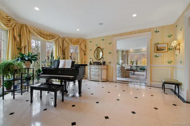 a very nice looking room with a large window and furniture