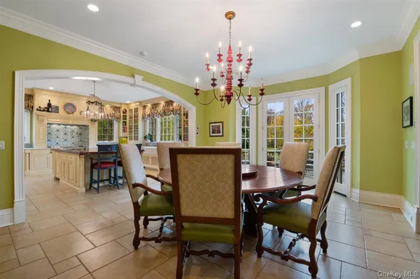 a view of a dining room with furniture and a chandelier