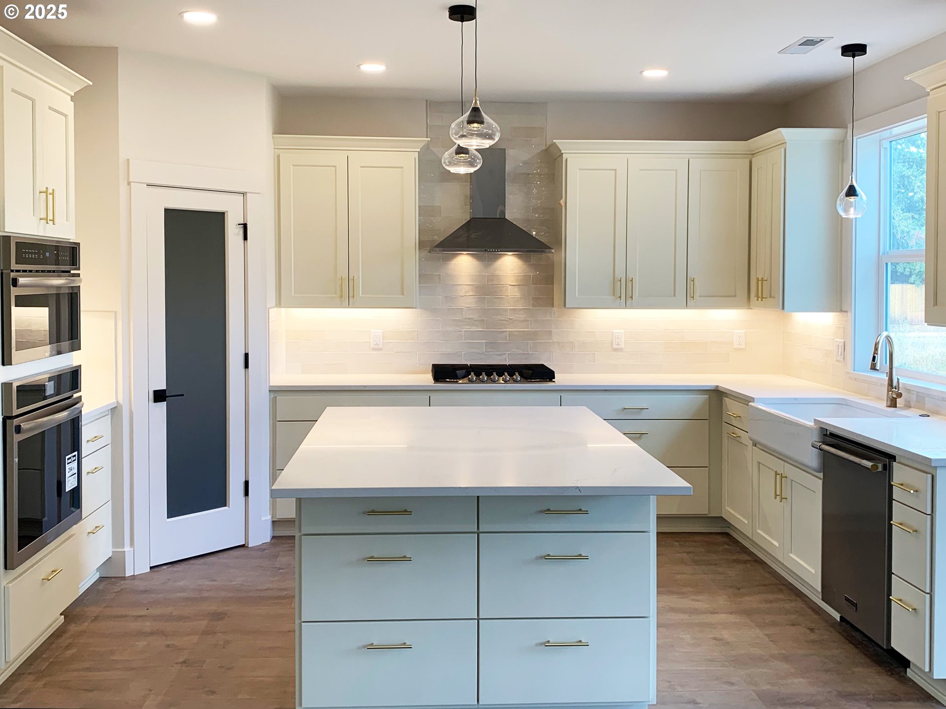 1896 South Holly Street Canby, OR 97013 - Photo 13 of 36 a kitchen with kitchen island white cabinets and stainless steel appliances