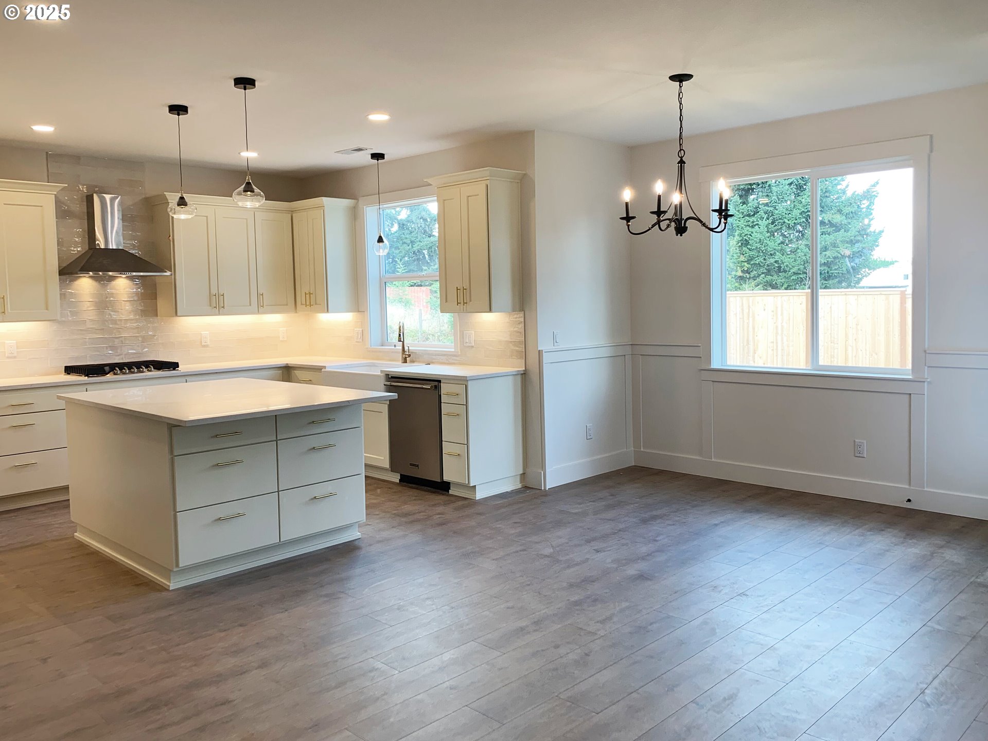 1896 South Holly Street Canby, OR 97013 - Photo 21 of 36 a kitchen with stainless steel appliances kitchen island hardwood floor sink stove and wooden floor