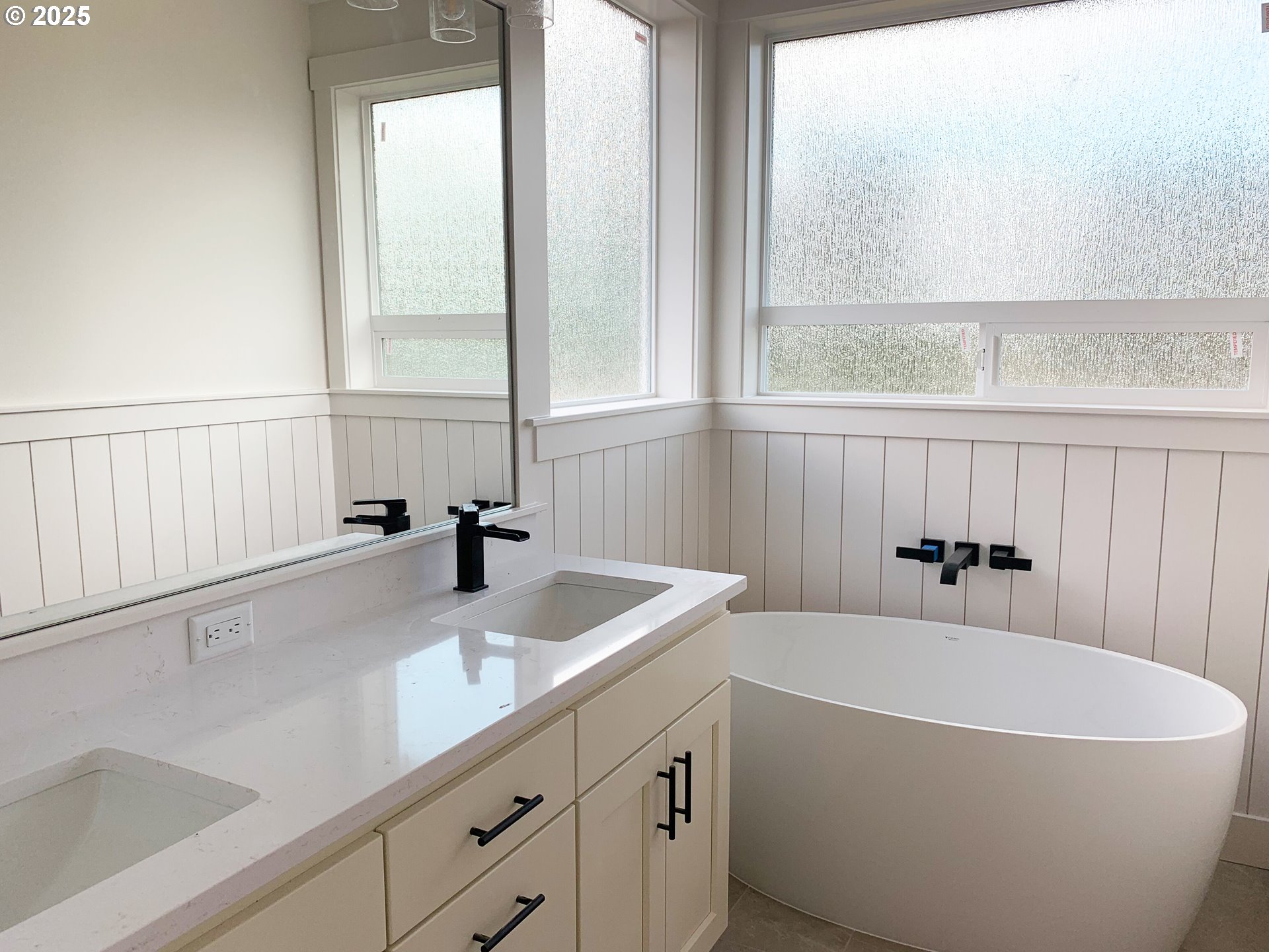 1896 South Holly Street Canby, OR 97013 - Photo 26 of 36 a bathroom with a white tub a sink and a window