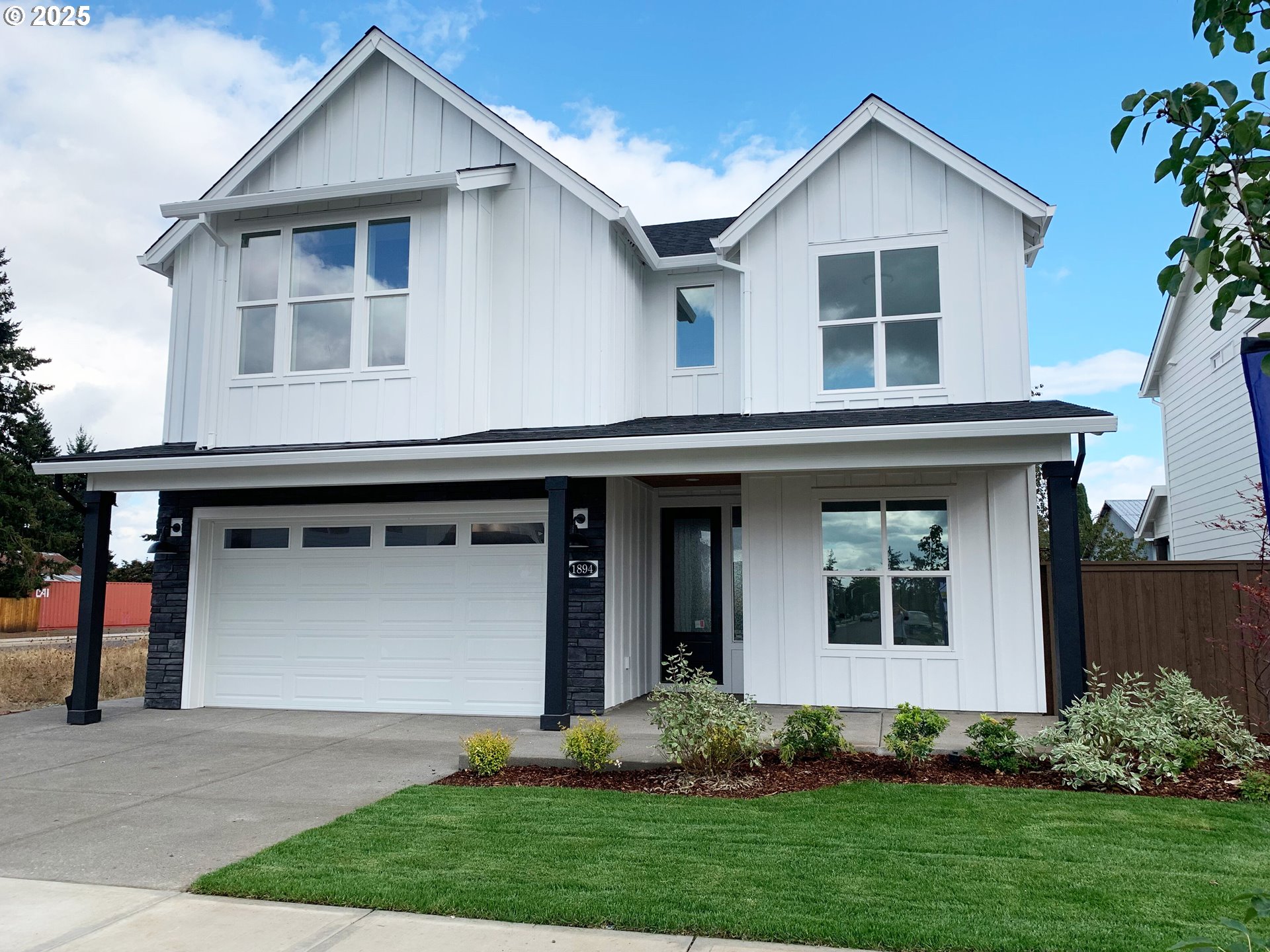 1896 South Holly Street Canby, OR 97013 - Photo 36 of 36 a front view of a house with a garden and plants