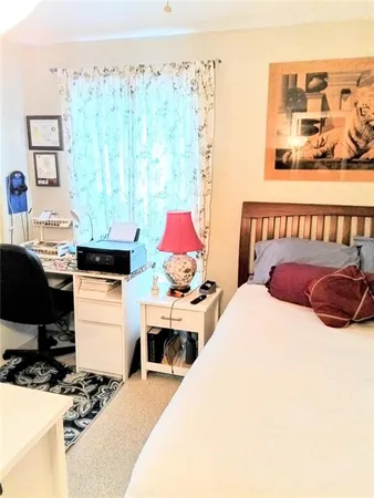 a bedroom with a bed and a table in it