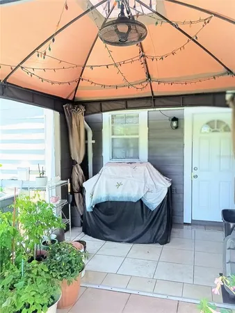 a bathroom with a toilet and a potted plant