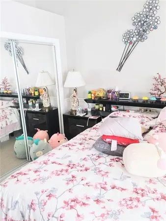 a bed room with a bed and a chair