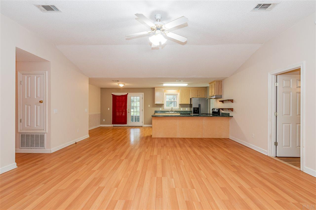 9890 Red Rock Road Milton, FL 32570 - Photo 5 of 36 View from the living room to the kitchen