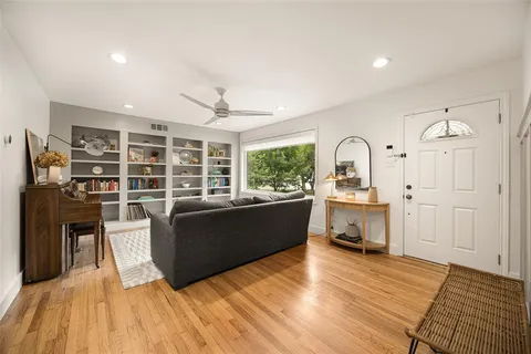 a living room with furniture window and wooden floor