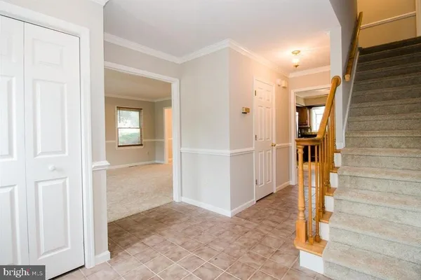 a view of an empty room with windows and fireplace