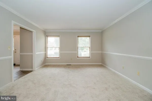 a view of backyard with small garden and outdoor seating
