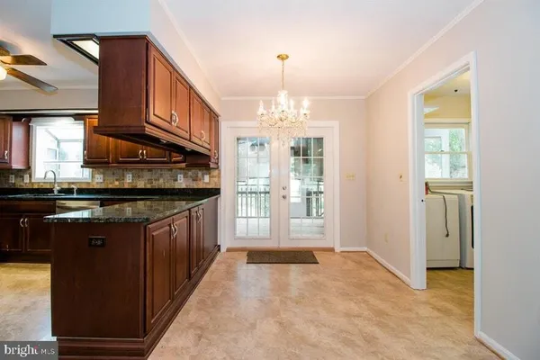 a view of a livingroom with a fireplace and a ceiling fan