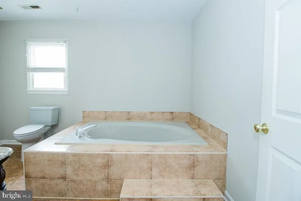 a view of a pathway with a garden