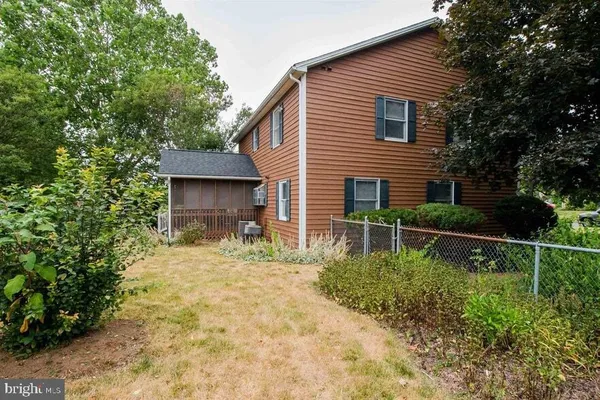 a bathroom with a granite countertop sink a toilet and tub
