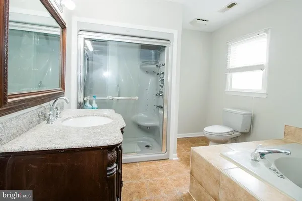 an empty room with a ceiling fan and a window