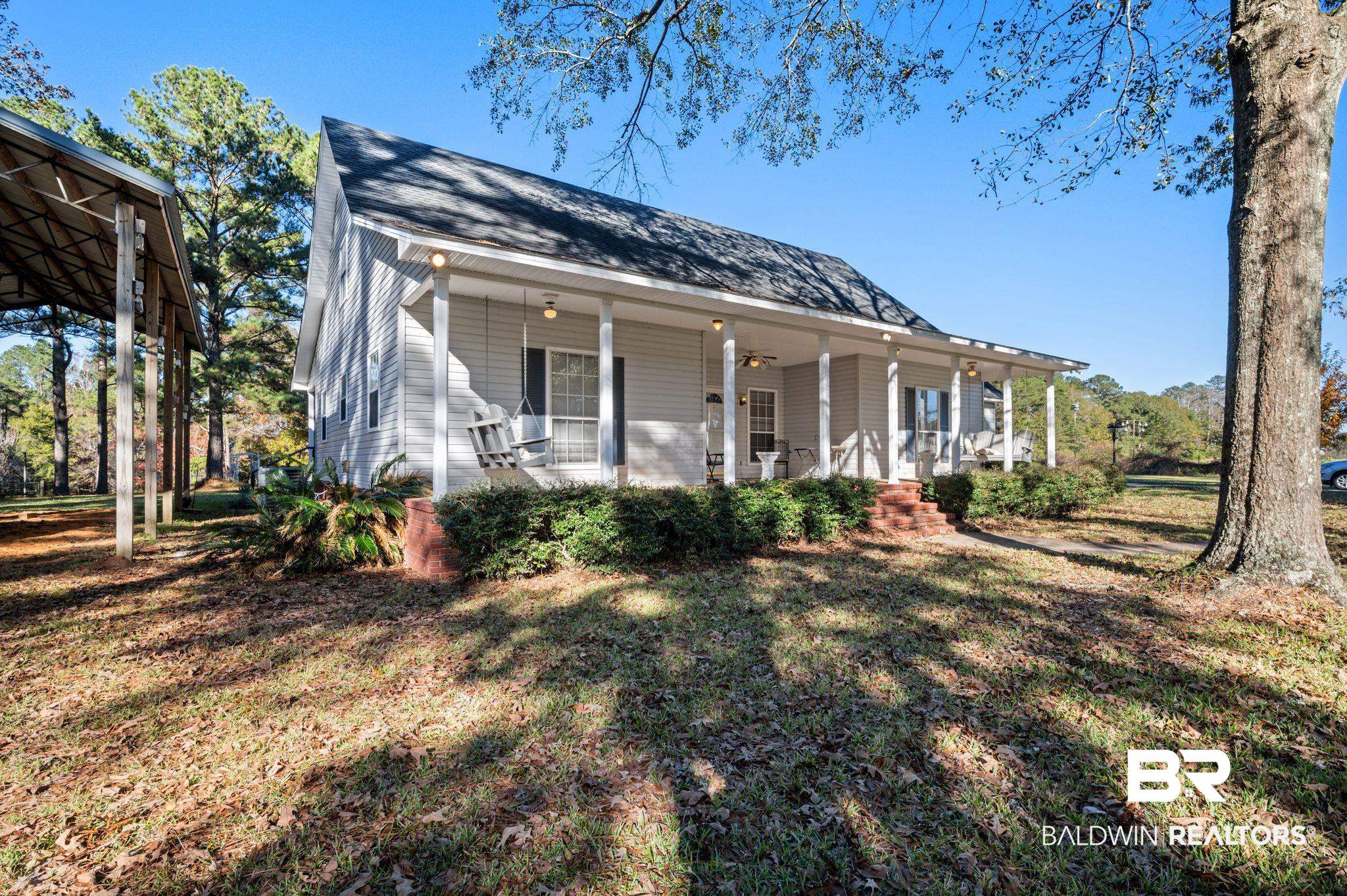 15801 Maytower Road Bay Minette, AL 36507 - Photo 3 of 43 View of front of house featuring covered porch and a front yard