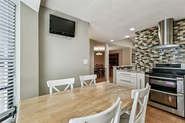 a living room with furniture a fireplace and a chandelier