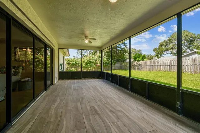 an aerial view of residential houses with outdoor space and trees