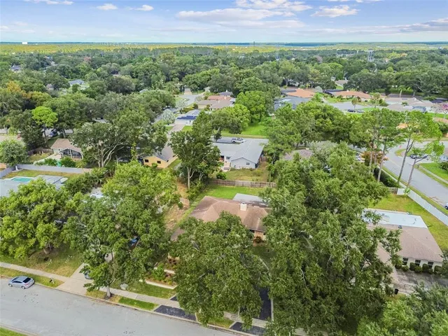 a view of a chairs and table on the wooden roof deck
