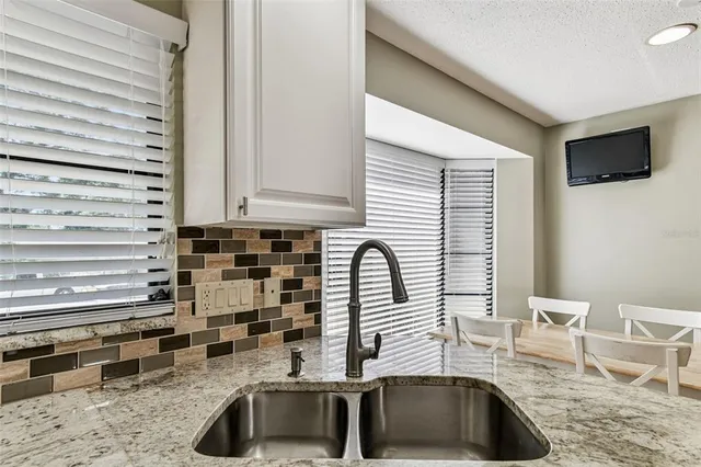 a kitchen with granite countertop a stove and a refrigerator