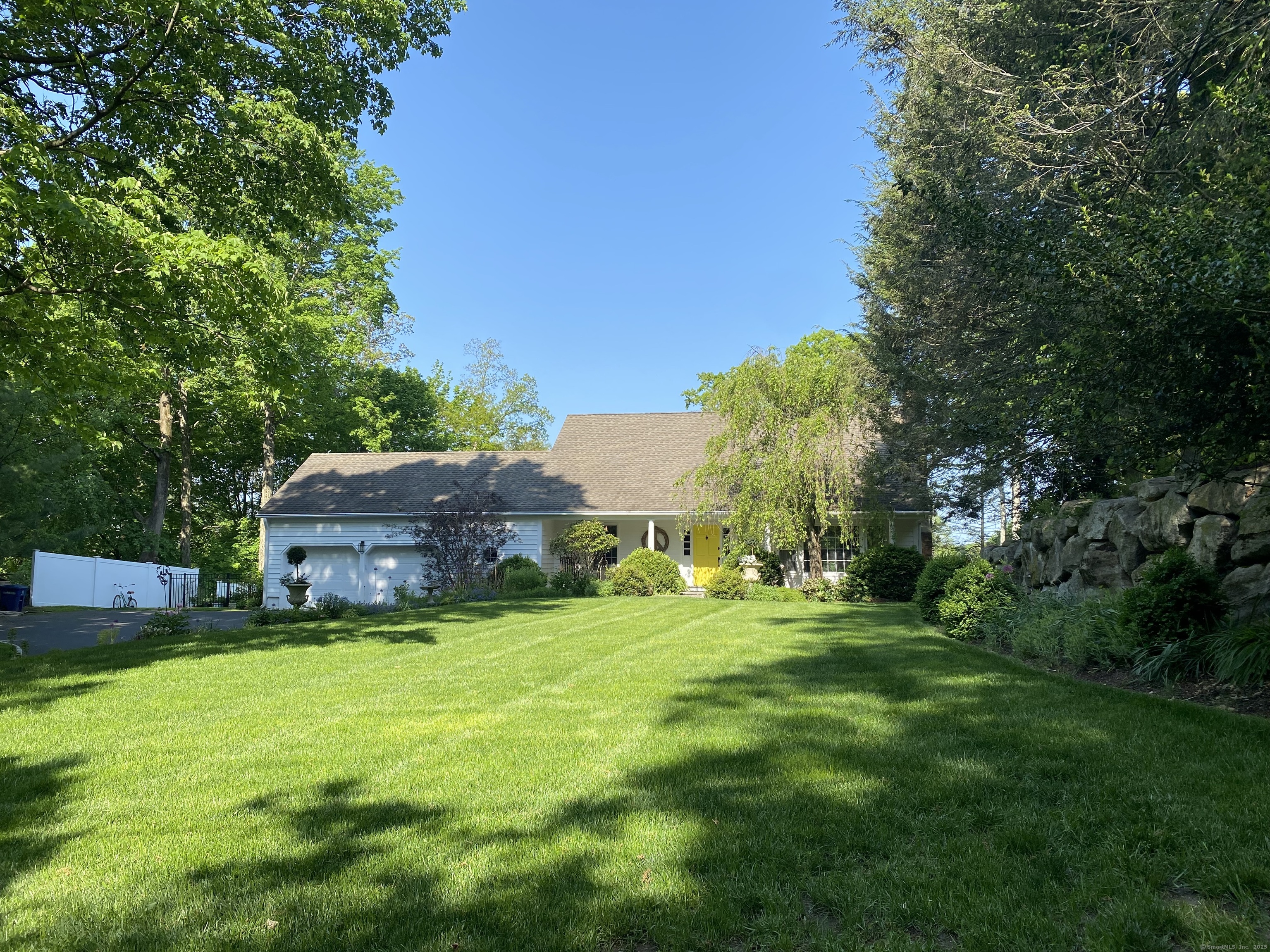 a view of a house with a yard and sitting area