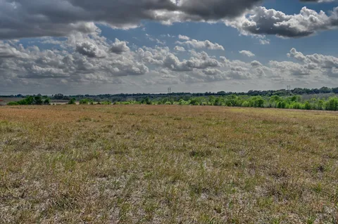 a view of a lake with houses in the back
