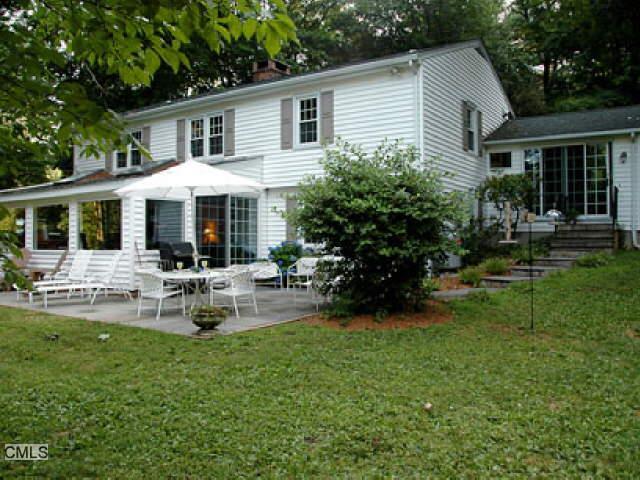 69 Partrick Road Westport, CT 06880 - Photo 1 of 1 a front view of house with yard and outdoor seating