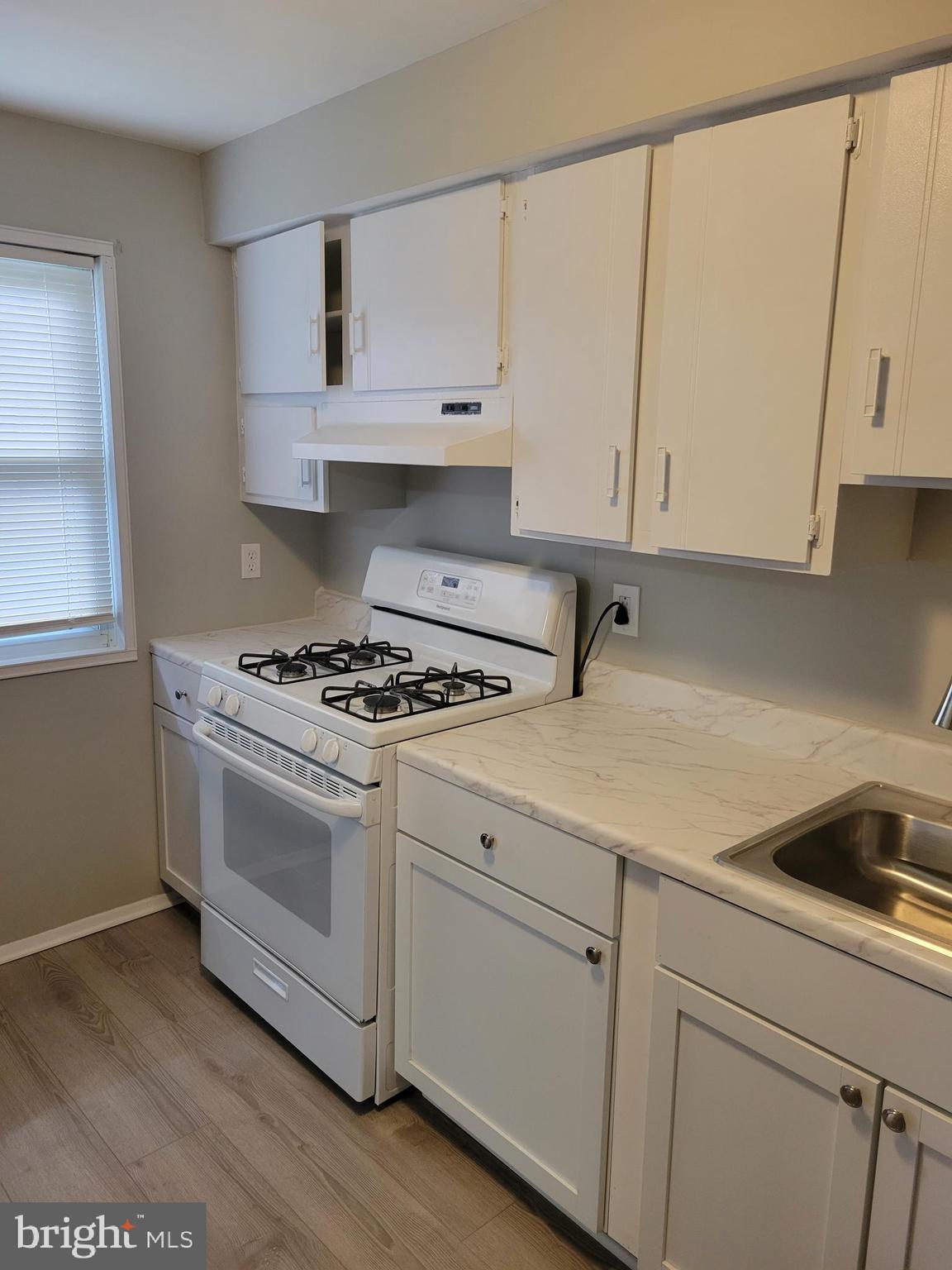 630 Kingston Road Baltimore, MD 21220 - Photo 11 of 34 a kitchen with white cabinets and white appliances