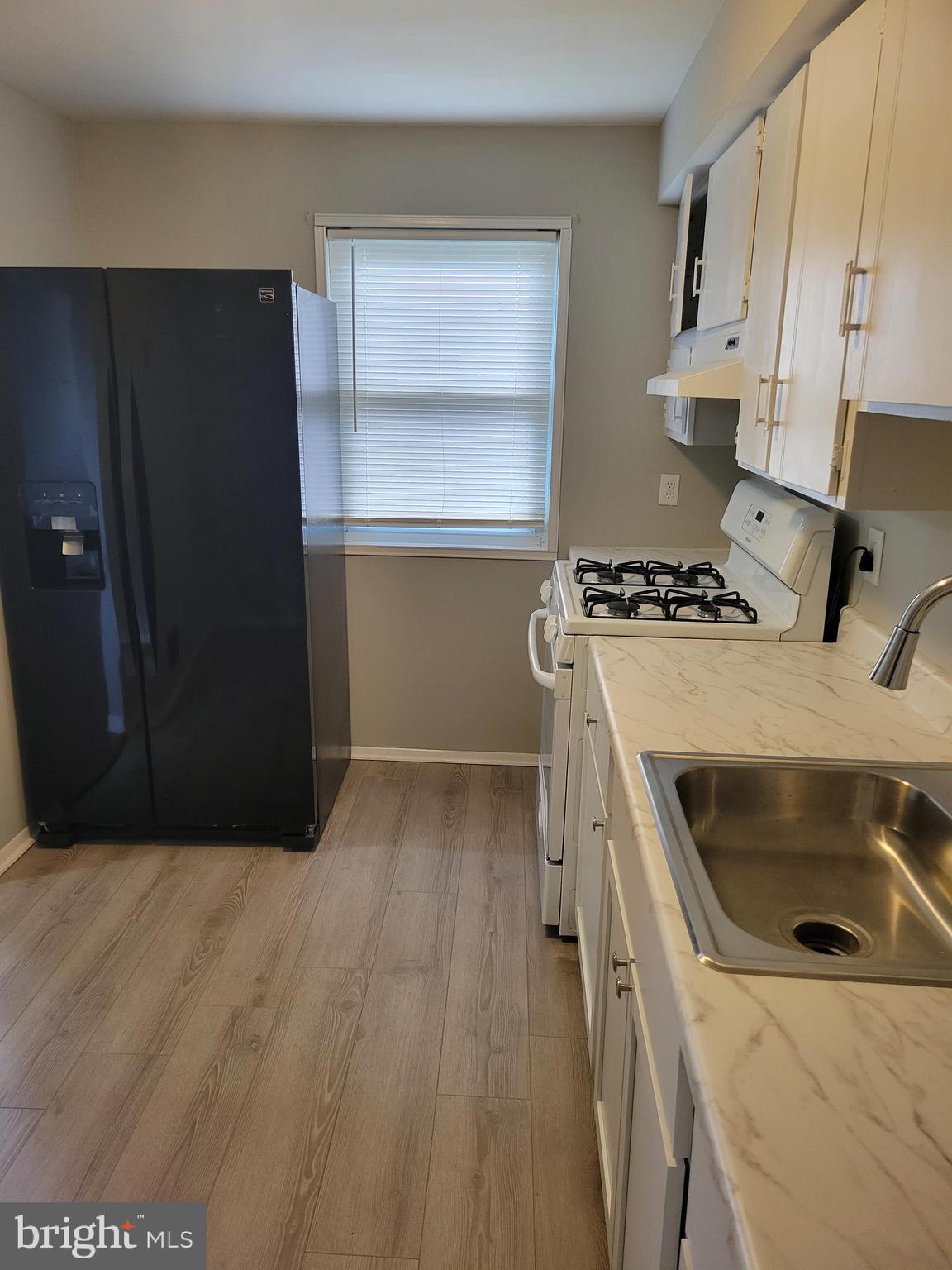 630 Kingston Road Baltimore, MD 21220 - Photo 12 of 34 a kitchen with a stove and a refrigerator