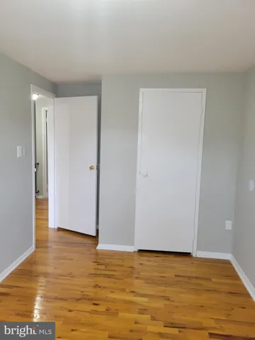 a view of an empty room and wooden floor
