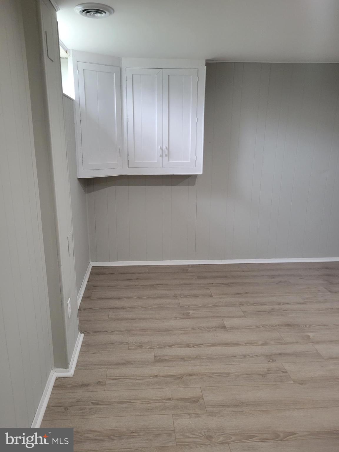 630 Kingston Road Baltimore, MD 21220 - Photo 30 of 34 a view of an empty room with wooden floor and cabinets