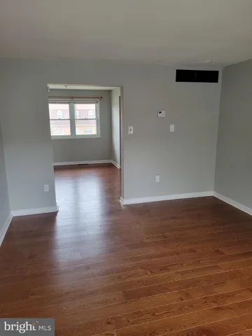 a view of wooden floor and windows in a room