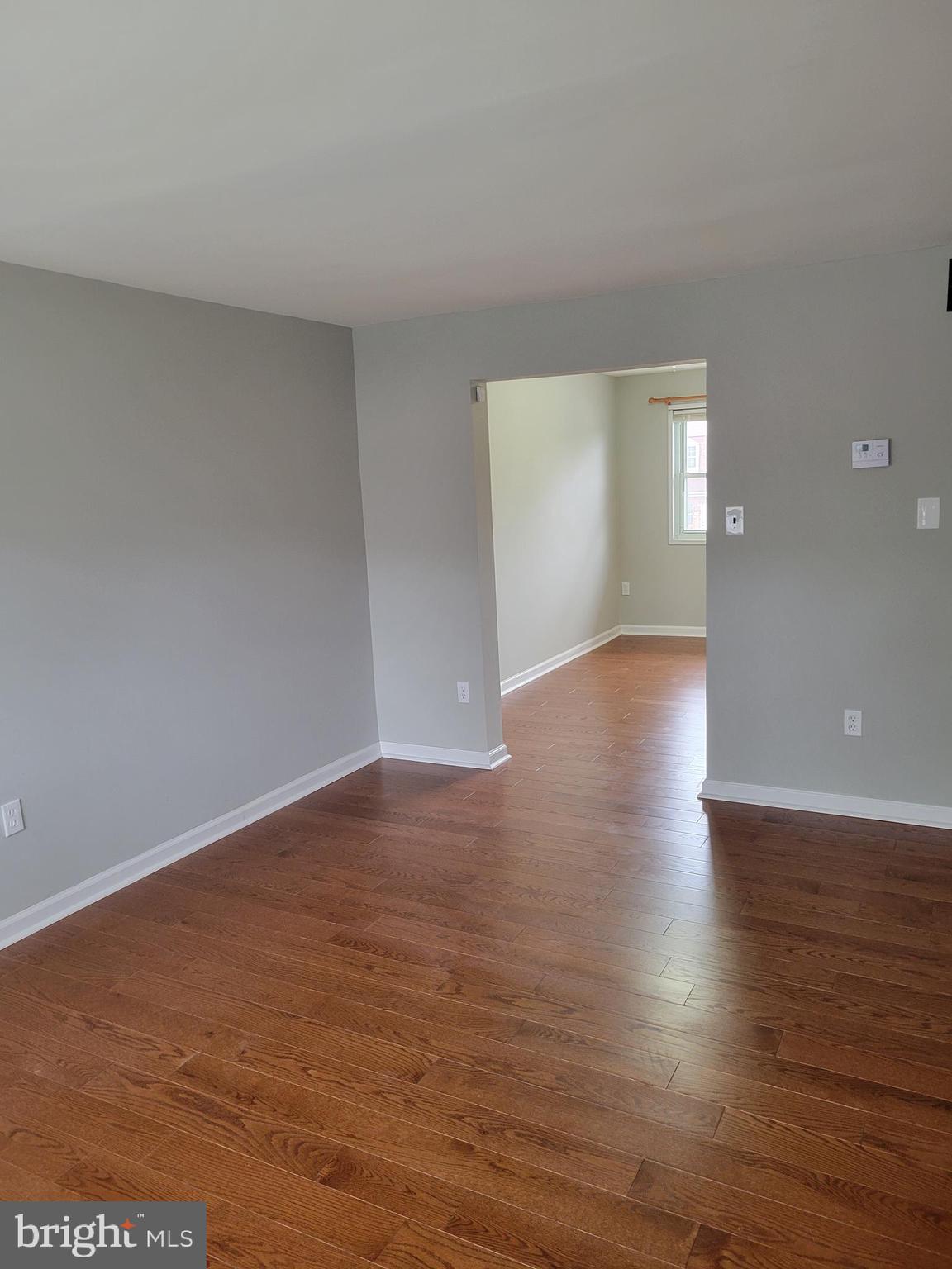 630 Kingston Road Baltimore, MD 21220 - Photo 5 of 34 a view of an empty room with wooden floor