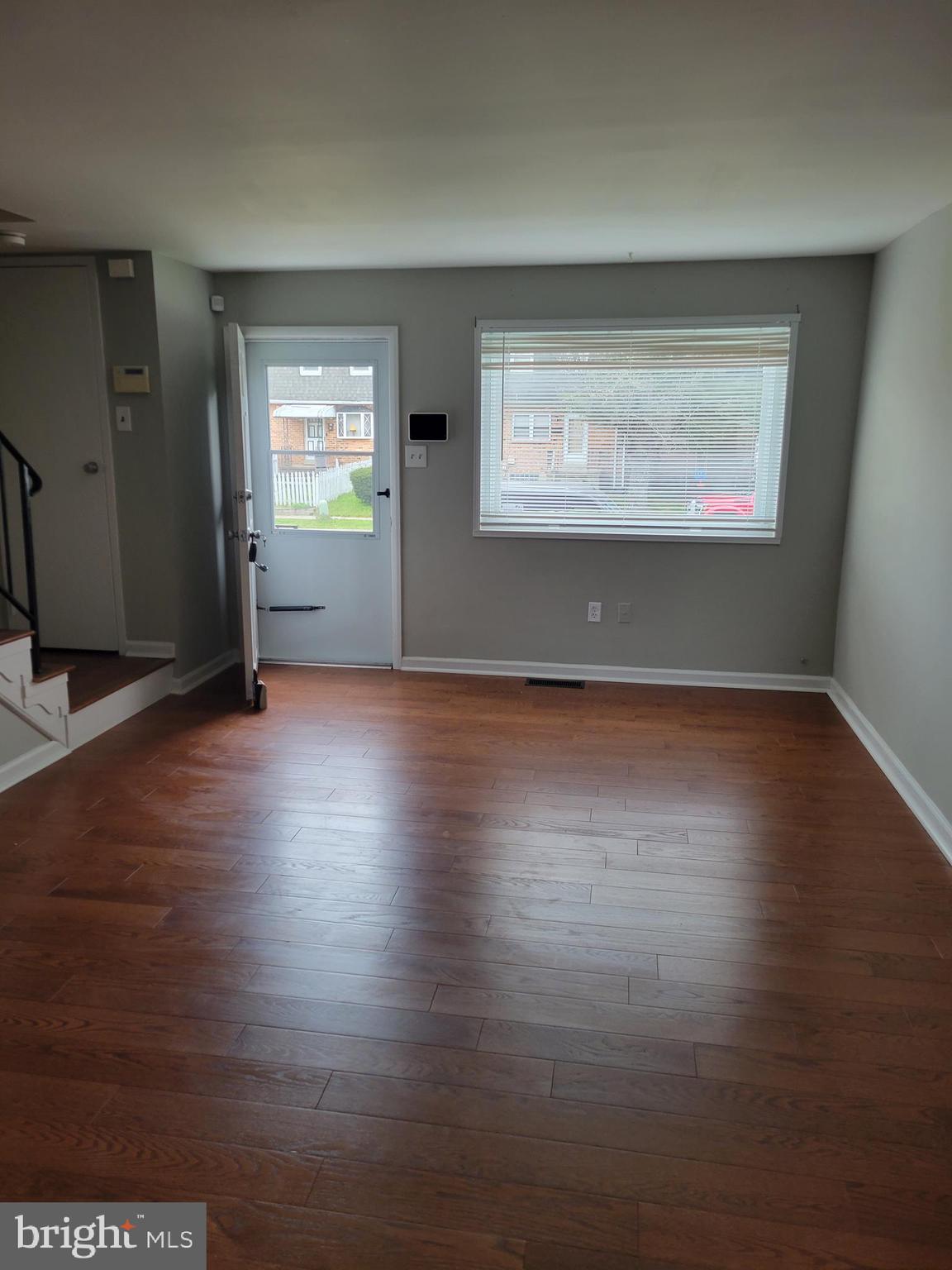 630 Kingston Road Baltimore, MD 21220 - Photo 6 of 34 an empty room with wooden floor cabinet and windows