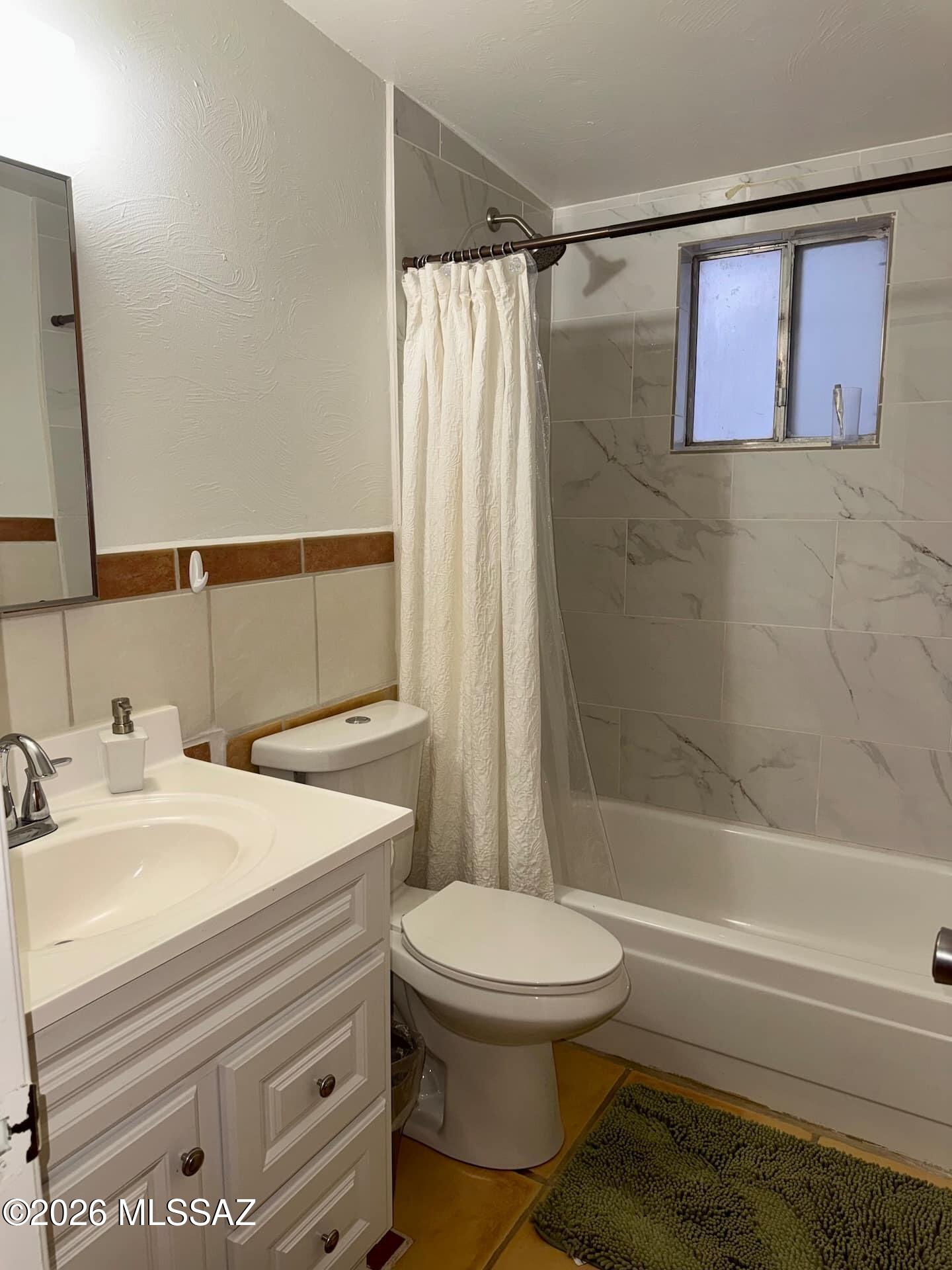 4415 North Swan Road Tucson, AZ 85718 - Photo 18 of 33 a bathroom with a sink toilet and shower