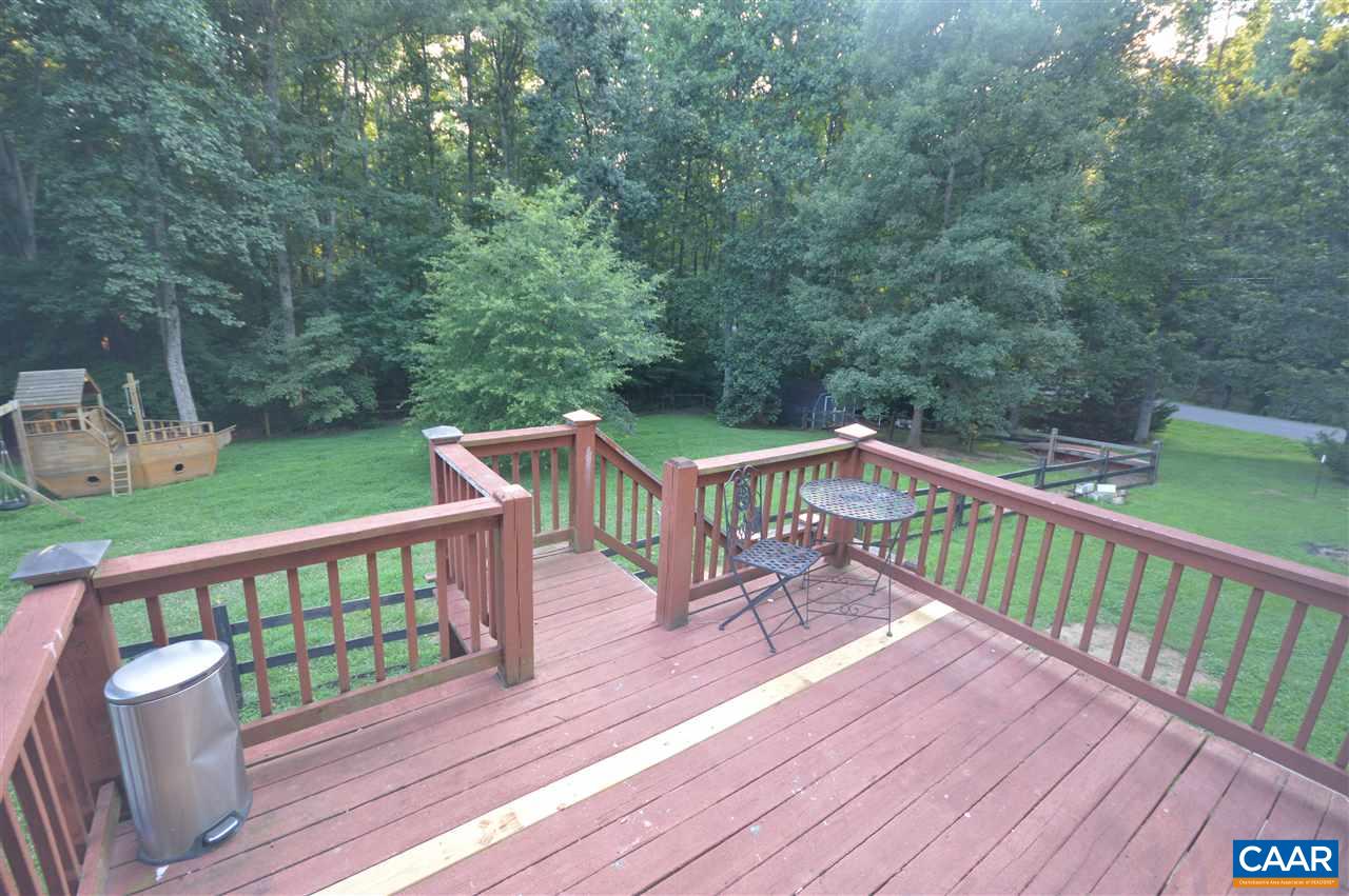389 Morning Glory Road Ruckersville, VA 22968 - Photo 11 of 34 a view of a wooden deck and yard with furniture