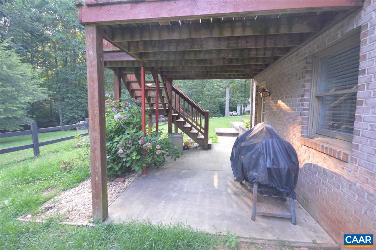 389 Morning Glory Road Ruckersville, VA 22968 - Photo 18 of 34 a view of a porch with a table and chairs under an umbrella